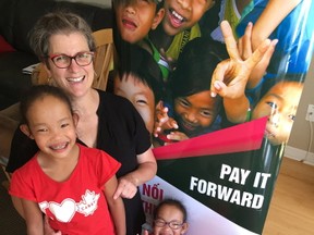 Johanne Wagner stands with her adopted children, from left, Binh, Phuoc and Toan. Wagner has launched a fundraiser to support renovations at a school in a remote area of the children’s homeland of Vietnam. Elliot Ferguson, Kingston Whig-Standard, Postmedia Network