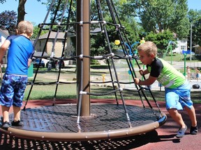 Andrew Friedman, 8, pushes 6-year-old brother Hayden on the playground in Cadzow Park on Friday, July 6, 2018 in St. Marys, Ont. Terry Bridge/Stratford Beacon Herald/Postmedia Network