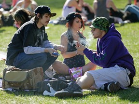 A group of people smoke joints at the Edmonton 420 marijuana rally on the Alberta Legislature grounds on April 20, 2016. Larry Wong/Postmedia Network