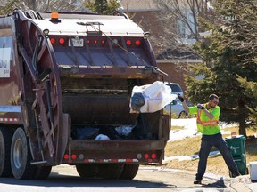 Garbage pickup in Ottawa on Wednesday March 30,2011. A city report proposes bi-weekly garbage pickup and weekly green bin pickup. (ERROL MCGIHON/THE OTTAWA SUN/QMI AGENCY)