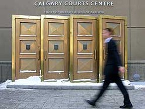 Pedestrians enter the Calgary Courts Centre in Calgary, Alta. (Photo by JIM WELLS/Calgary Sun)