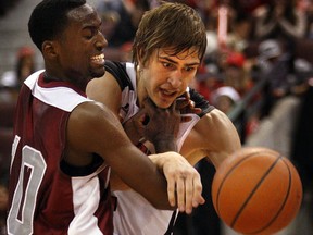 The 5th Annual MBNA Capital Hoops Classic took place at Scotiabank Place in Ottawa Wednesday January 26, 2011. Carleton Raven Tyson Hinz tries to get past Ottawa Gee Gee Warren Ward during the fourth quarter Wednesday night. The Carleton Ravens defeated the Ottawa Gee Gees 78-65.  TONY CALDWELL/OTTAWA SUN