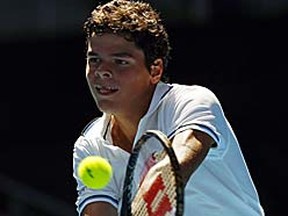 Milos Raonic plays a shot to David Ferrer during their match at the Australian Open on Monday. (REUTERS/Petar Kujundzic)