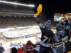 Pittsburgh Penguins fans cheer on their team in the first period against the Washington Capitals during the NHL's Winter Classic hockey game at Heinz Field in Pittsburgh, Pennsylvania January 1, 2011. (REUTERS/Pam Panchak)