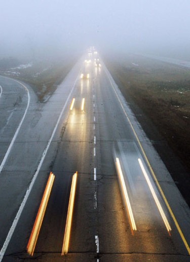Dense fog created poor visibility on Hwy. 417 in Kanata Saturday, January 1, 2011. The temperature was only a few degrees shy of breaking a 45-year-old-record. (Darren Brown/Ottawa Sun)