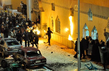 Egyptian riot police attempt to put out fire started by Christians outside a mosque in Alexandria, 230 km (140 miles) north of Cairo on Jan. 1, 2011. (REUTERS)