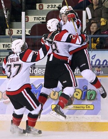 Ottawa 67's rookie Sean Monohan (R) celebrates his first OHL goal with teammates Nicholas Foglia (#37) and Cosimo Fontana (#28) during second period action against the Mississauga St. Michael's Majors at the Ottawa Civic Centre on Sunday October 3,2010. (Errol McGihon/The Ottawa Sun)