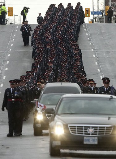 Thousands of law enforcement and emergency personnel walk in a procession to the funeral for murdered Ottawa police officer Constable Eric Czapnik in Ottawa, Ontario on Thursday January 7,2010. (ERROL MCGIHON/OTTAWA SUN)