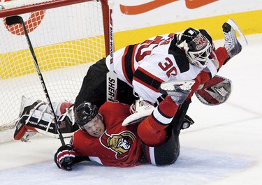 Ottawa Senators Milan Michalek crashes into New Jersey Devils goaltender Martin Brodeur during second period action at Scotiabank Place on Tuesday January 26, 2010. (ERROL MCGIHON/THE OTTAWA SUN)