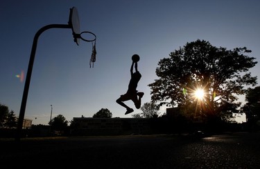 June 1/2010   Parfait Kingway gets some air while playing basketball at Coronation Park in Ottawa Tuesday evening.   Tony Caldwell/QMI Agency