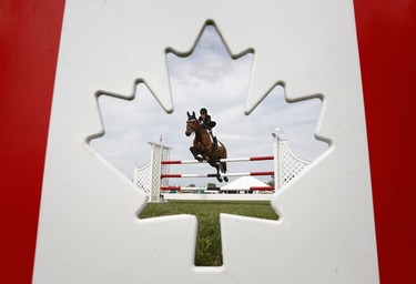 Aug 14/2010   Jordan MacPherson rides his horse Romanov over a jump during the $10,000 Modified Grand Prix Saturday in Ottawa.  Tony Caldwell/Ottawa Sun