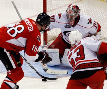 Ottawa Senators' Jesse Winchester (18) tries to tip the puck past Carolina Hurricanes' goalie Cam Ward (30) while Jeff Skinner (53) looks on during the third period of NHL action at Scotiabank Place Wednesday, December 29, 2010. Hurricanes shut out the Sens 4-0. (Darren Brown/Ottawa Sun)