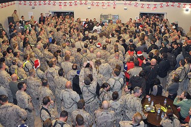 Canadian troops in Afghanistan gather around hockey icon Don Cherry during a surprise visit on Dec. 25, 2010. (CANADIAN ARMED FORCES)