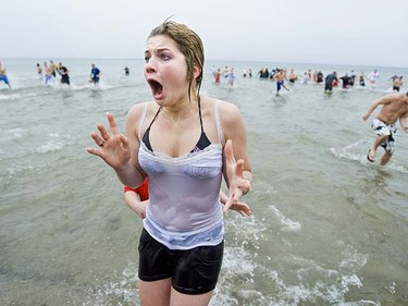 Dana Daiken reacts to the cold water of Lake Ontario as she heads for the shore in the 25th annual Oakville, Ont. Polar Bear dip on January 1, 2010.  (QMI Agency/Ernest Doroszuk)