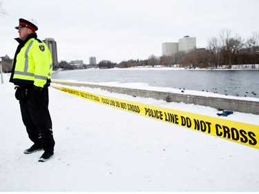 An Ottawa Police Oficer guards the scene at Strathcona Park where efforts were made to rescue a nine year old boy from the Rideau River. Tuesday December 21,2010. (ERROL MCGIHON/THE OTTAWA SUN)