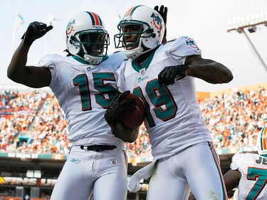 Miami Dolphins Davone Bess (L) celebrates with teammate Brandon Marshall after Marshall scored a touchdown against the Buffalo Bills during the fourth quarter of their NFL football game in Miami, Florida on Dec. 19, 2010. (REUTERS)