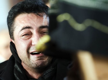 Ali Ghiasi, wails as he watches his son, Yazdan Ghiasi's, casket as it's carried out of the Ottawa Mosque Thursday, December 9, 2010.  (Darren Brown/Ottawa Sun)