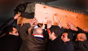 The casket of Yazdan Ghiasi is carried into the Ottawa Mosque as friends and family grieve during the funeral service Thursday, December 9, 2010.  (Darren Brown/Ottawa Sun)