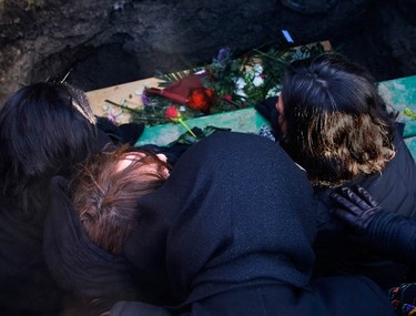 Second from lett, Negin, the mother of murder victim, Yazdan Ghiasi, mourns over the her sons casket at Beechwood Cemetery Thursday, December 9, 2010.  (Darren Brown/Ottawa Sun)
