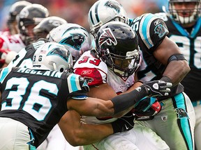 Atlanta Falcons running back Michael Turner (33) is tackled by a host of Carolina Panthers defenders during an NFL football game in Charlotte, North Carolina on Dec. 12, 2010. (REUTERS)