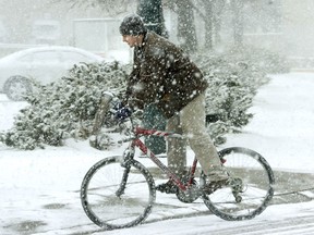 A man on a bicycle drives through a snow storm. (QMI AGENCY FILE)