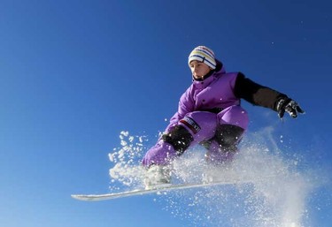 Charlie Holloway makes a jump on his snowboard at the Queen Elizabeth country park near Petersfield in southern England Friday. (REUTERS/Luke MacGregor)