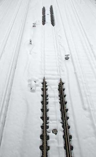 Snow covers rail tracks on the line to Gatwick Airport, in southern England Thursday. More heavy snow caused havoc across Britain on Thursday, keeping Gatwick closed for a second day, disrupting rail services and leaving travellers stranded. (REUTERS/Luke MacGregor)