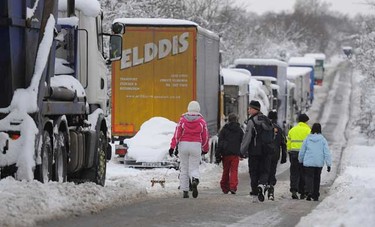 Vehicles are seen where they have been stranded for two days due to snow on the A57 road near Worksop, northern England Thursday. Around 200 people were stranded on the road overnight and had to be rescued by mountain rescue crews after heavy snow, local media reported. (REUTERS/Nigel Roddis)