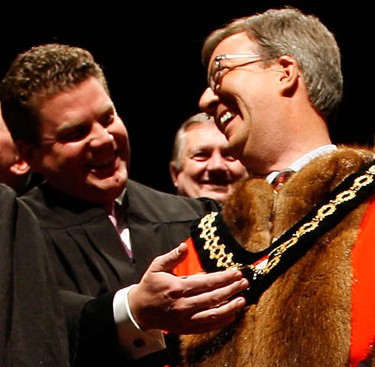 Coun. Jim Desroches checked out Jim Watson's robe during the inauguration of the 2010-2014 City of Ottawa Council  at the Shenkman Arts Centre in Orleans Wednesday, December 1, 2010. (Darren Brown/Ottawa Sun)