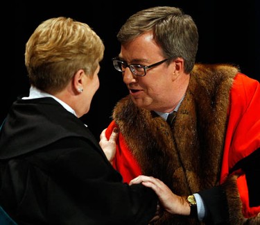 Jim Watson shakes hands with Claudette Cain during the inauguration ceremony for the 2010-2014 City of Ottawa Council at the Shenkman Arts Centre in Orleans Wednesday, December 1, 2010. (Darren Brown/Ottawa Sun)