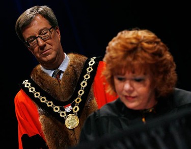 Jim Watson looks on as Coun. Jan Harder sign in during the inauguration of the 2010-2014 City of Ottawa Council ceremony at the Shenkman Arts Centre in Orleans Wednesday, December 1, 2010. (Darren Brown/Ottawa Sun)