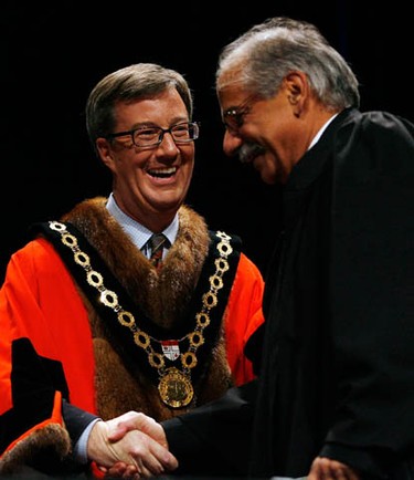 Jim Watson shakes the hand of Shad Qadri before he signs in during the inauguration of the 2010-2014 City of Ottawa Council ceremony at the Shenkman Arts Centre in Orleans Wednesday, December 1, 2010. (Darren Brown/Ottawa Sun)