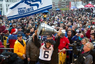 The Grey Cup parade made its way down Ste-Catherine street Wednesday as Alouettes players greeted thousands of fans. (REUTERS/Christinne Muschi)