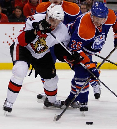 Ottawa Senators' Milan Michalek (9) fights for the puck against Edmonton Oilers' Kurtis Foster (26) during the first period of NHL action at Scotiabank Place Monday, November 29, 2010.  (Darren Brown/Ottawa Sun)