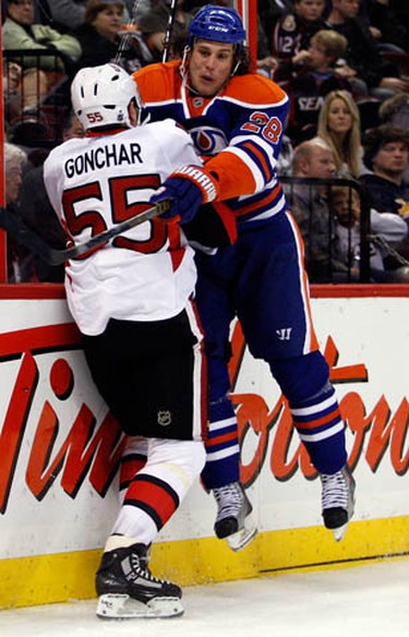 Ottawa Senators' Sergei Gonchar (55) is checked into the boards by Edmonton Oilers' Ryan Jones (28) during the second period of NHL action at Scotiabank Place Monday, November 29, 2010.  (Darren Brown/Ottawa Sun)