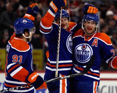From left, Edmonton Oilers' Magnus Paajarvi (91) and Ladislav Smid (5) celebrate a goal by Tom Gilbert (77) during the second period of NHL action at Scotiabank Place Monday, November 29, 2010.  (Darren Brown/Ottawa Sun)