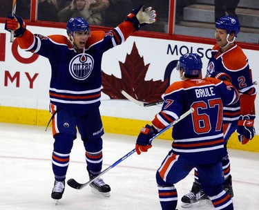 Edmonton Oilers' Andrew Cogliano (13) celebrates his third period goal with teammates, Gibert Brule (67) and Jim Vandermeer (2) during the third period of NHL action at Scotiabank Place Monday, November 29, 2010. Oilers won 4-1. (Darren Brown/Ottawa Sun)