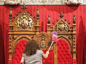A member of the cleaning staff dust the Senate thrones in Ottawa. (Chris Roussakis, QMI Agency file photo)