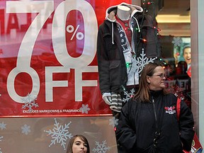Shoppers take a break outside a store on "Black Friday." Brendan McDermid/REUTERS FILES