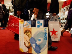Shoppers carry their Christmas purchases. (QMI Agency file photo)