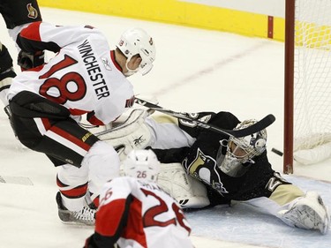 Ottawa Senators' Jesse Winchester (18) scores against Pittsburgh Penguins goalie Marc-Andre Fleury in the first period of their NHL hockey game in Pittsburgh, Pennsylvania, November 26, 2010. REUTERS/Jason Cohn
