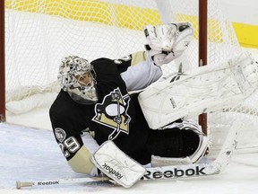 Pittsburgh Penguins goalie Marc-Andre Fleury makes a glove save against the Ottawa Senators in the first period of their NHL hockey game in Pittsburgh, Pennsylvania, November 26, 2010. REUTERS/Jason Cohn