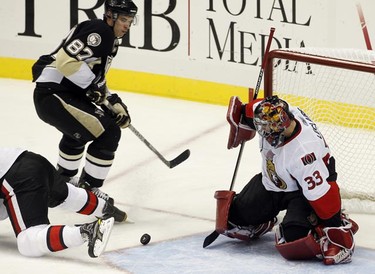 Ottawa Senators goalie Pascal Leclaire (33) blocks a shot by Pittsburgh Penguins' Sidney Crosby (87) in the second period of their NHL hockey game in Pittsburgh, Pennsylvania, November 26, 2010. REUTERS/Jason Cohn
