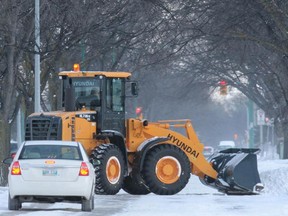 A snow plow gets to work on Burrows Avenue in Winnipeg Friday, Nov. 19, 2010. Ten cm of snow fell on the city, introducing Winnipeggers to the winter of 2010-11. (MARCEL CRETAIN/WINNIPEG SUN)