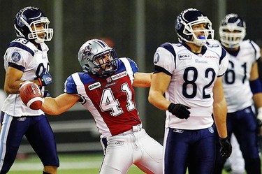 Montreal Alouettes Ivan Brown (41) celebrates an interception surrounded by Toronto Argonauts Spencer Watt (L) Chad Rempel (82) and Cedric Gagne-Marcoux during the CFL East Division final football game in Montreal, on Nov. 21, 2010.  (REUTERS)