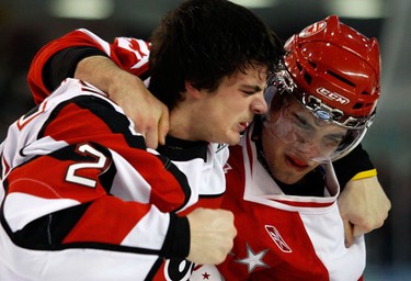 Ottawa 67s' Julian Luciano (25) unloads on  Sault Ste. Marie Greyhounds' David Quesnele (23) during the second period of OHL action at the Civic Centre Sunday, November 14, 2010.  David Quesnele (23) hurt his shoulder in the fight.  (Darren Brown/Ottawa Sun)