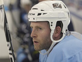 Ryan Whitney watches the action from the bench during the Oilers training camp. (PERRY NELSON/QMI Agency)