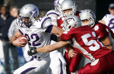 University of Western Ontario Mustangs' Jerimyy Hipperson (22) breaks away from University of Ottawa GeeGees' Tyler Sawyer (52) during the first quarter of action at Frank Clair Stadium in the Yates Cup Saturday, November 13, 2010.  (Darren Brown/Ottawa Sun)