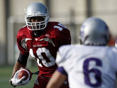 University of Ottawa GeeGees' Cyril Adjeitey eyes up approaching University of Western Ontario Mustangs'Aaron Handor (6) during the first quarter of action at Frank Clair Stadium in the Yates Cup Saturday, November 13, 2010.  (Darren Brown/Ottawa Sun)