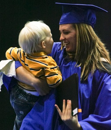 Almost-two-year-old Colten Pluta is scooped up by his graduating aunt Jennifer Carlson after her name was called at Mount Royal University's Convocation 2010 in Calgary on Friday November 5, 2010. LYLE ASPINALL/QMI AGENCY